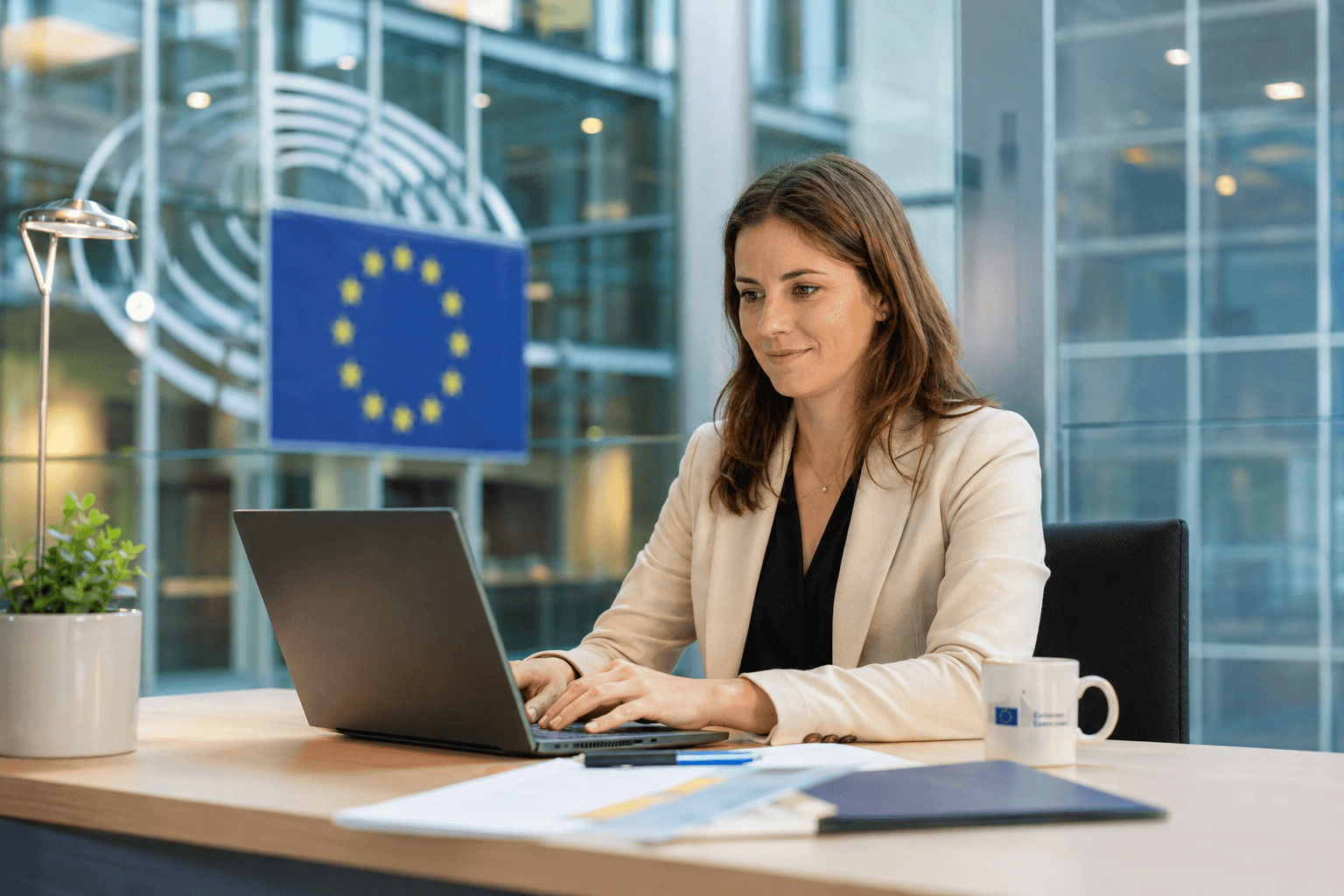A professional working at a desk inside a modern EU institution building